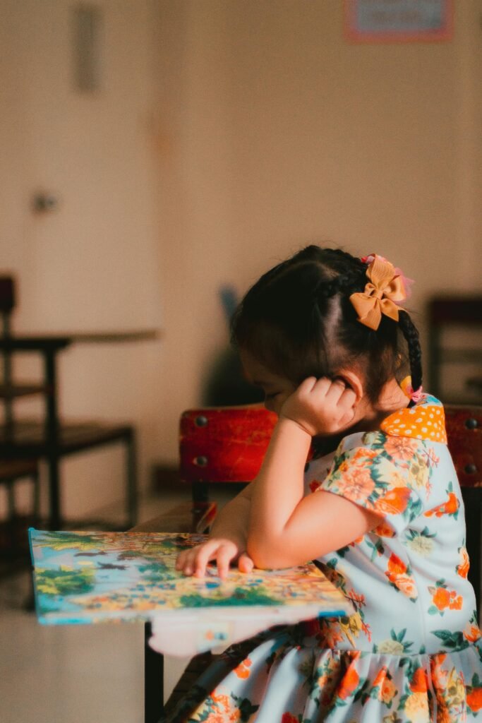 A young child reading in the study room at the Courtney Jordan Foundation headquarters in the Philippines, benefiting from the foundation’s educational programs.