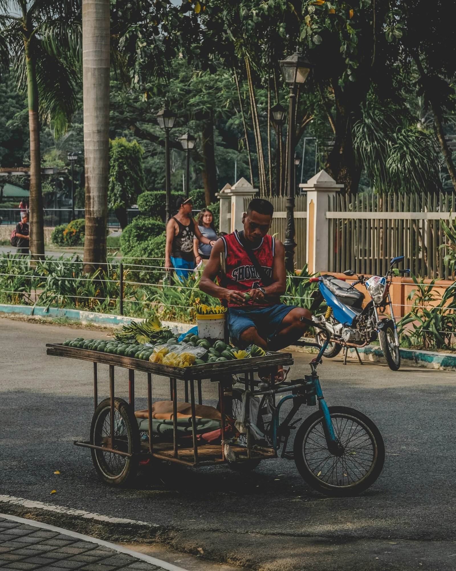 Filipino entrepreneur Jun Reyes with his mobile fruit cart in Taguig, representing CJF Philippines Kabuhayan Recovery program success story